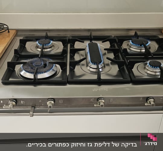 כיריים גז עם להבות פעילות במטבח מודרני